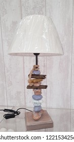 Retro Lamp In Driftwood And Beach Pebbles