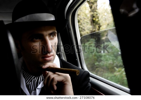 retro man with cigar in the\
car