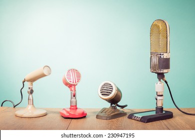 Retro mass media microphones for broadcasting or recording front mint green wall background