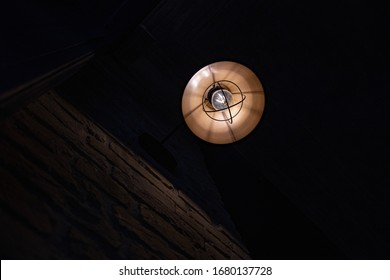 Retro Metal Lampshade With Glass Light Bulb Inside. Glowing Vintage Streetlight Closeup On Dark Background With Copy Space. Lighting Concept.