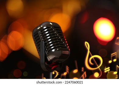 Retro microphone, music notes and other musical symbols against festive lights, closeup