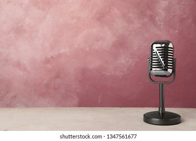 Retro microphone on table against color background. Space for text - Shutterstock ID 1347561677