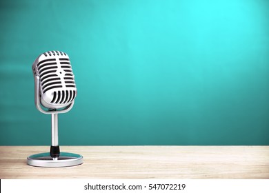 Retro Microphone On Wooden Table With Turquoise Wall Background