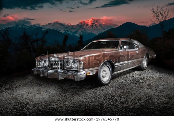 Retro muscle car on the\
mountains background. Vintage car. Old mobile outdoor. Ford\
Thunderbird \
