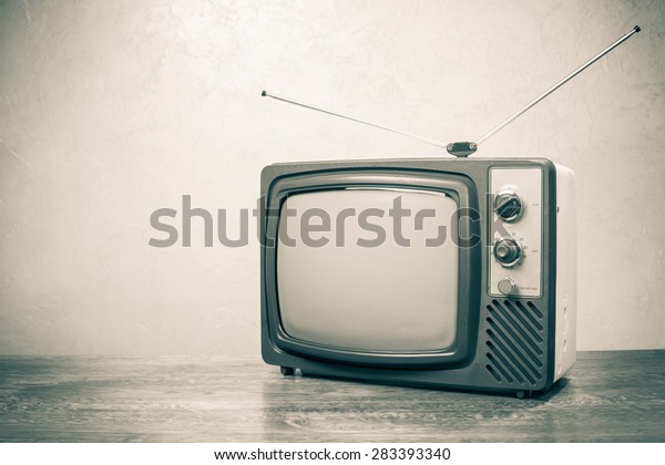 Retro\
obsolete TV from 70s. Vintage old style sepia\
photo
