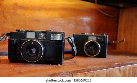 Retro Old camera stack of vintage books on wood background tables, vintage color tones 