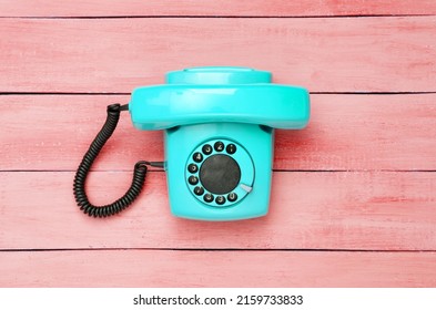 Retro Old Fashioned Blue Rotary Phone On Red Wooden Table. Top View