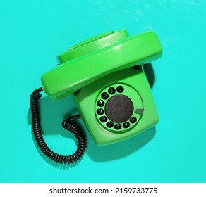 Retro Old Fashioned Green Rotary Phone On Blue Background. Top View