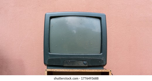 Retro Old Gray TV Set Receiver On Wooden Table Front View Pink Wall Background Close-up