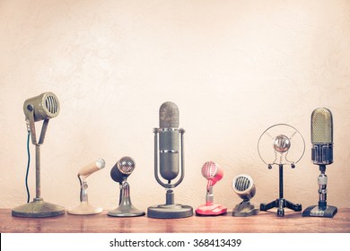 Retro old microphones on table. Vintage style filtered photo