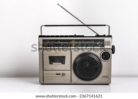 Retro old radio on white wall background, front view