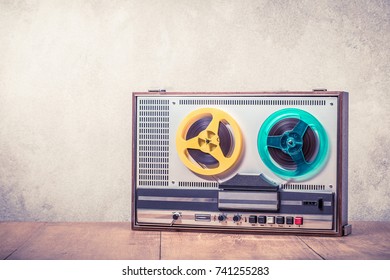 Retro Old Reel To Reel Tape Recorder Front Concrete Wall Background. Vintage Style Filtered Photo