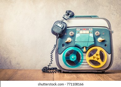 Retro Old Reel To Reel Tape Recorder And Headphones Front Concrete Wall Background. Vintage Instagram Style Filtered Photo