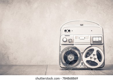 Retro Old Reel To Reel Tape Recorder Front Concrete Wall Background. Vintage Style Sepia Photo