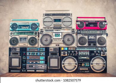 
Retro old school design ghetto blaster stereo radio cassette tape recorders boombox tower from circa 1980s front concrete wall background. Vintage instagram style filtered photo