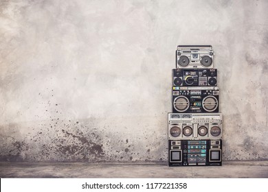Retro old school design ghetto blaster boombox  stereo radio cassette tape recorders tower from circa 1980s front concrete wall background. Vintage style filtered photo - Shutterstock ID 1177221358