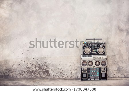 Retro old school design ghetto blaster boombox stereo radio cassette tape recorders from 80s front concrete wall background. Nostalgic Rap, Hip Hop, R&B music concept. Vintage style filtered photo Stock fotó © 