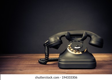 Retro Old Telephone On Table Front Dark Background