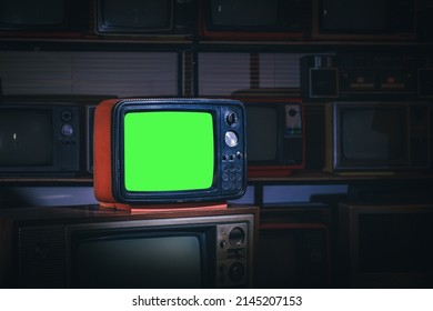 Retro Old Television With Green Screen In The Old Storage Room. Vintage Old Tv Technology.