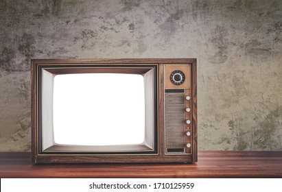 Retro Old Television On Wooden Table In Front Of Concrete Wall Background, Classic TV With Cut Out Screen