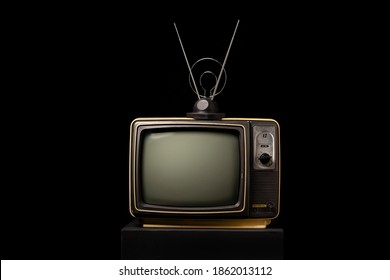 Retro old TV with antenna on black background