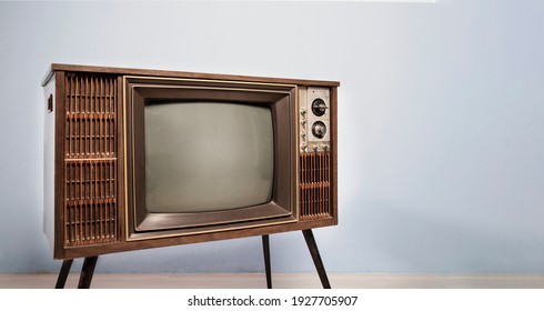 Retro old TV with blank screen standing in the room,  vintage television photo, side view