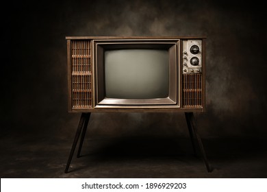 Retro Old TV Standing In A Dark Room, Antique And Vintage Television Style Photo.