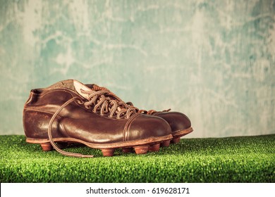 Retro outdated soccer or football spike boots. Vintage old style filtered photo