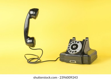 Retro phone with the handset off on a yellow background. The old technique. A place for your text. - Shutterstock ID 2396009243