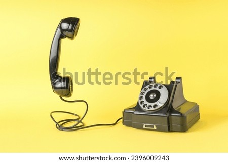 Retro phone with the handset off on a yellow background. The old technique. A place for your text.