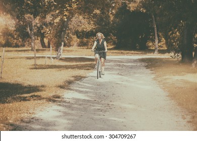 Retro Photo Of Middle Aged Woman With Bicycle At The Park