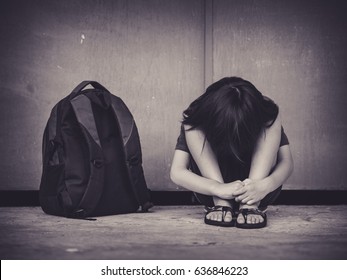 Retro Picture With Grain. Sad Kid Sitting On The Floor With School Bag Waiting For Parent.