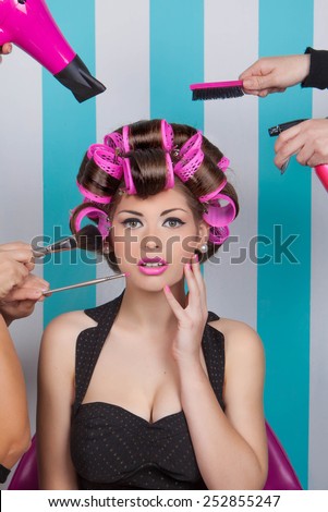 retro pin up woman getting pampered  in beauty salon