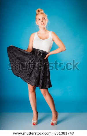 Retro pin up woman style. Beauty young full length girl on blue background in studio.