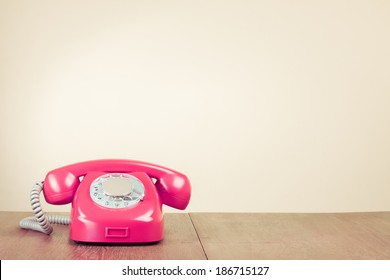 Retro Pink Rotary Telephone On Wood Table