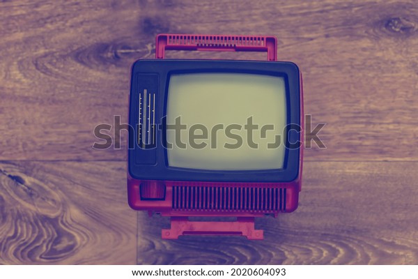 Retro portable mini tv\
on wooden floor