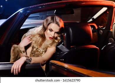 Retro Portrait Of A Beautiful Luxury Gatsby Woman In Black Cabriolet Car. Vogue Fashion Style And Smoke. Hollywood Look. Copy Space