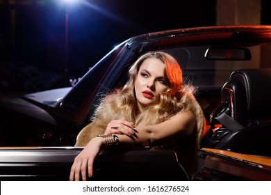 Retro Portrait Of A Beautiful Luxury Gatsby Woman In Black Convertible Car. Vogue Fashion Style And Smoke. Hollywood Look. Copy Space