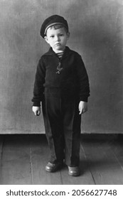 Retro Portrait Of Standing Little Boy In Beret. Vintage Black And White Paper Photo. Early 1960s. Old Surface, Soft Focus. Transferred Property, Family Archive.