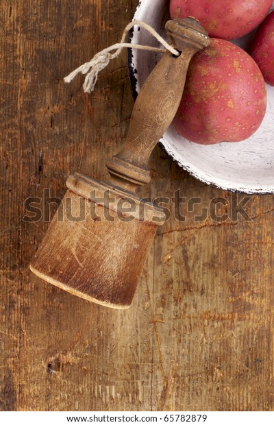 old wooden potato masher