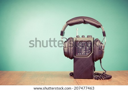 Retro radio, headphones front mint green background