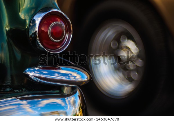Retro rear headlight lamp\
vintage classic car. Soft focus, boke background with copy space.\
Close-up view part of a vintage old car with bubble bokeh\
effect.
