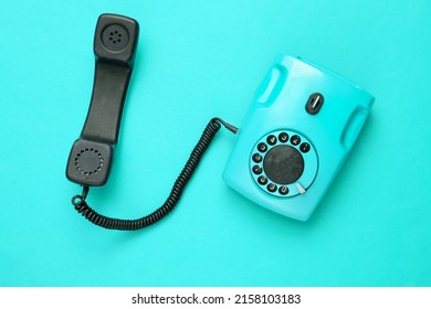 Retro Red Old Fashioned Rotary Phone On Blue Background. Top View