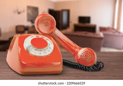 A Retro Red Old Telephone On A Table.