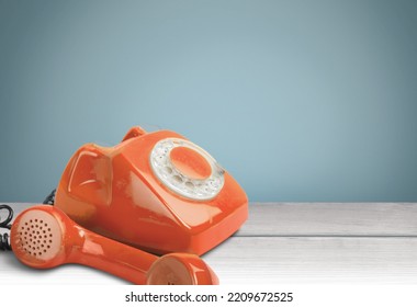 A Retro Red Old Telephone On A Table.