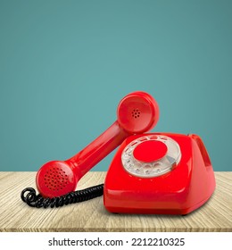 A Retro Red Old Telephone On A Table.