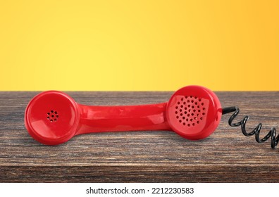 A Retro Red Old Telephone On A Table.