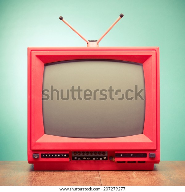 Retro red old television from 80s front mint\
green wall background