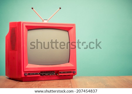 Retro red old television front mint green background