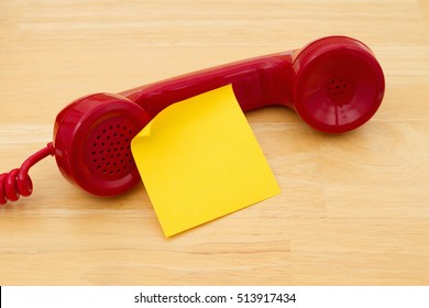 A Retro Red Phone With Yellow Sticky Note On A Desk With Copy Space For Your Message